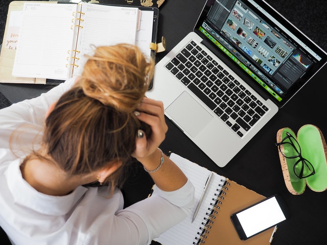 stressed woman near laptop