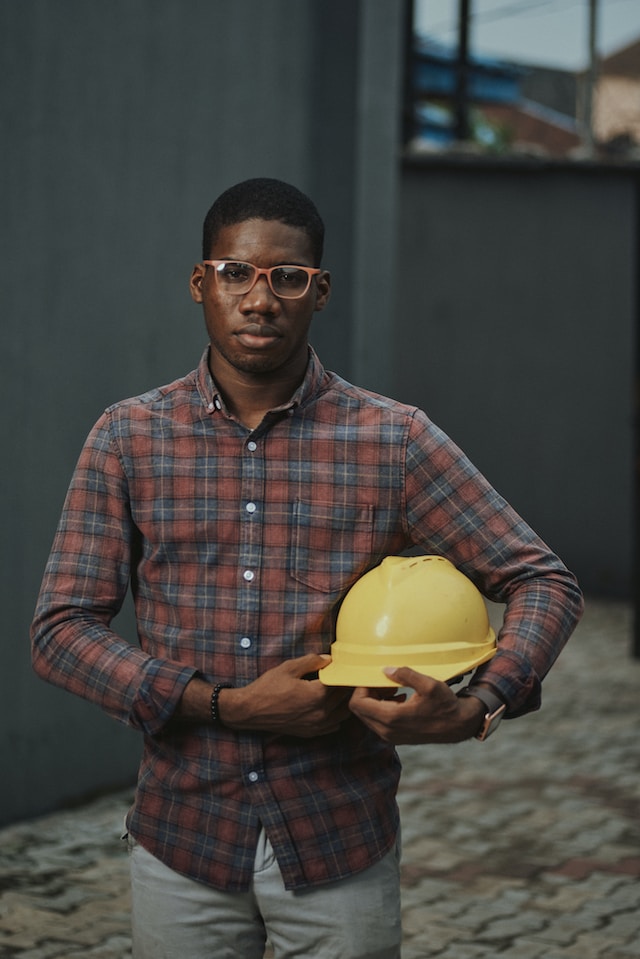 engineer holding a yellow safety helmet